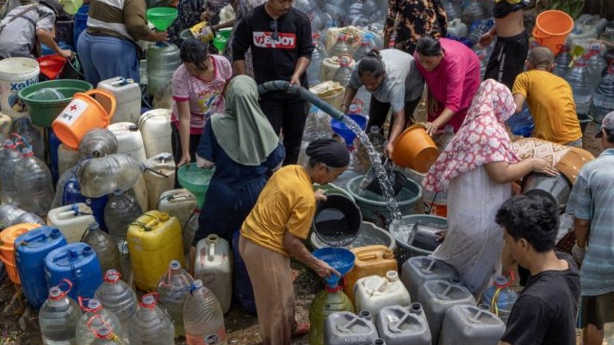 Residents queue for clean water donated by an NGO in Ridogalih village in Bekasi, West Java, Indonesia, on Oct 12, 2026.