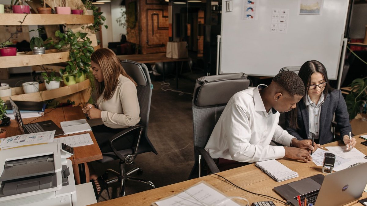 Teamwork in a modern office with diverse colleagues working together on documents.