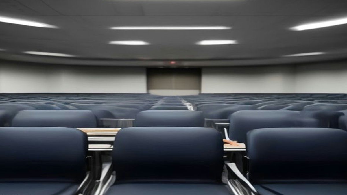 Executives seated in conference hall.