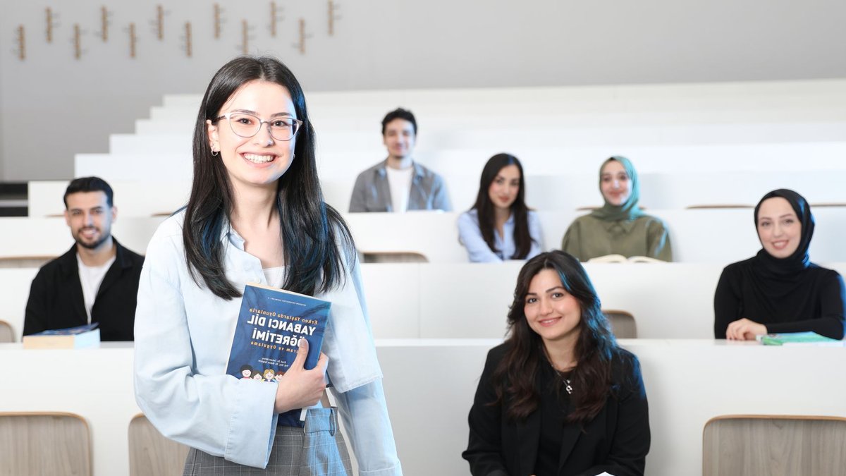 Group of diverse university students in a bright lecture hall, studying language education.