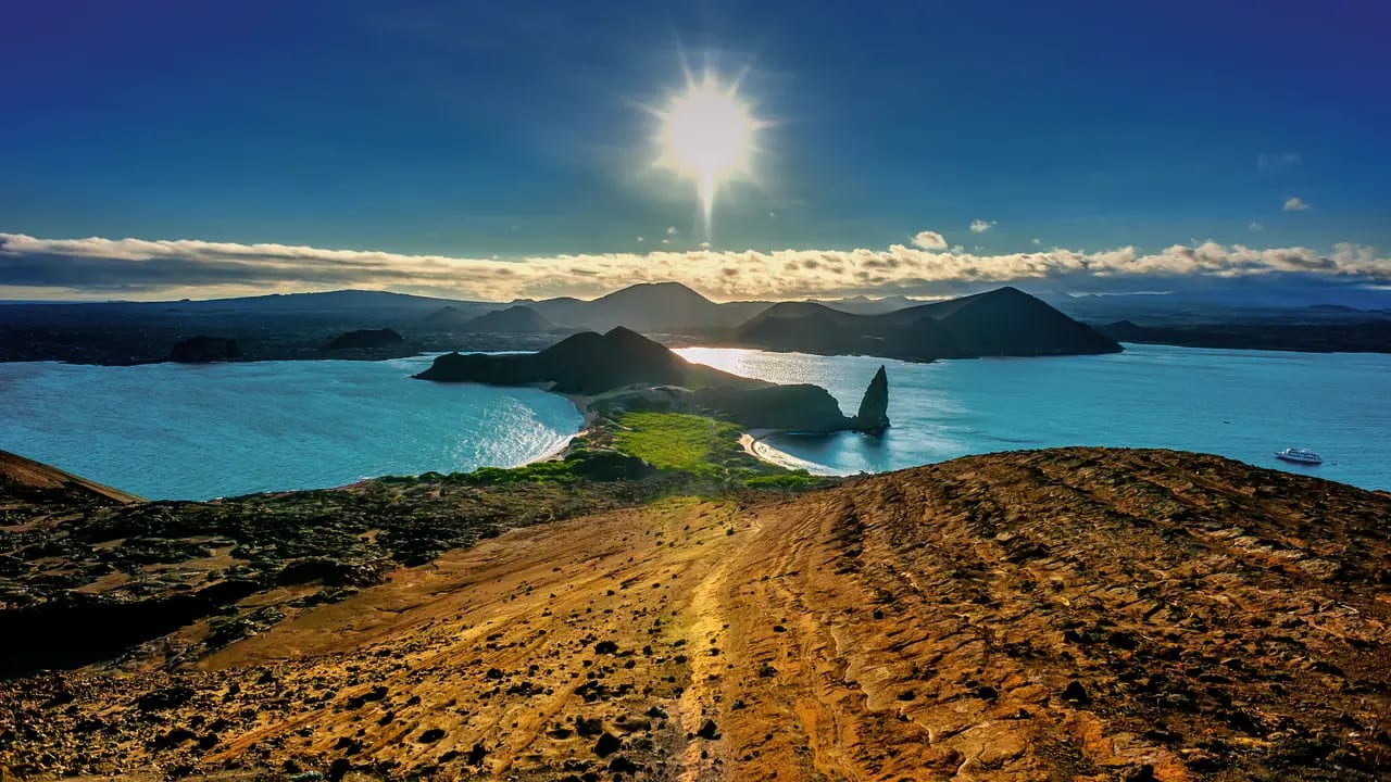 A stunning aerial view of the Galápagos Islands featuring dramatic volcanic islands, pristine