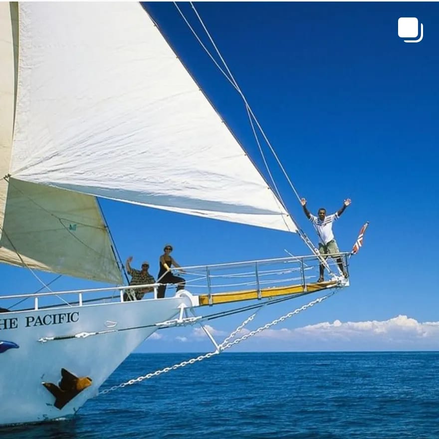 A vibrant sailing experience aboard The Pacific with passengers enjoying the open ocean under