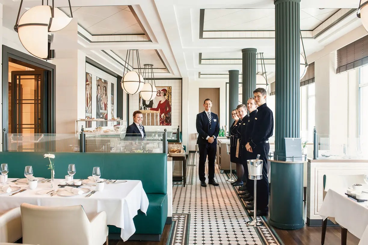 A sophisticated fine dining restaurant interior featuring elegant Art Deco design with teal