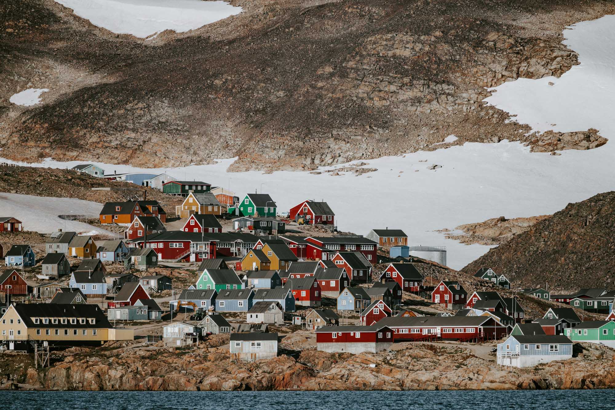 A vibrant Arctic settlement featuring densely packed houses painted in traditional bright