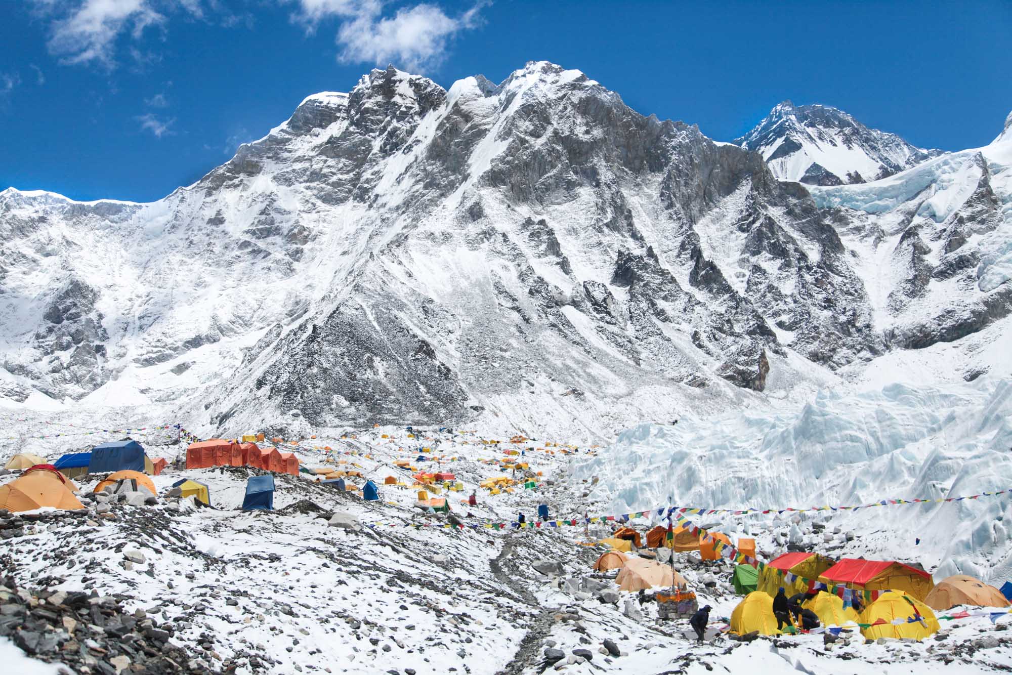 A vibrant base camp at the foot of Mount Everest featuring numerous colorful expedition tents