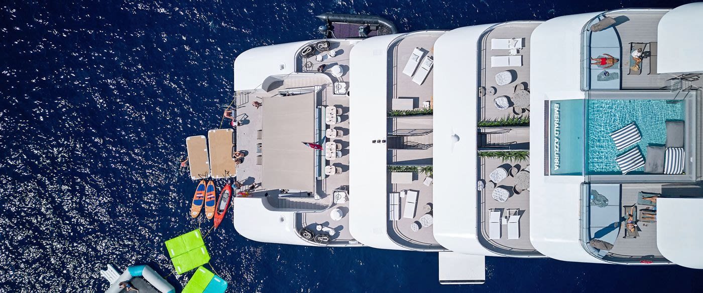 An aerial overhead view of the Emerald Azzurra expedition yacht moored in deep blue Mediterranean