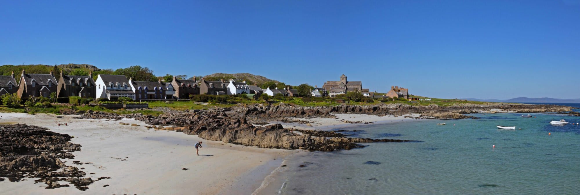 A picturesque Scottish coastal settlement featuring traditional stone architecture with distinctive