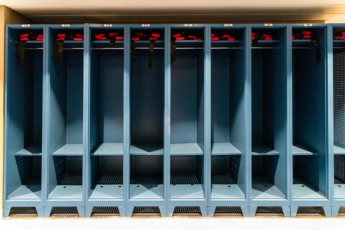 A row of individual crew quarters lockers aboard the Ocean Victory cruise ship, featuring numbered