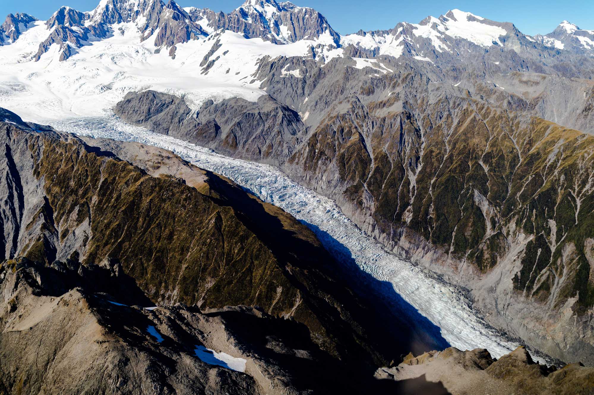 An aerial photograph taken from a helicopter showing Fox Glacier (Te Moeka o Tūawe) in Westland Tai