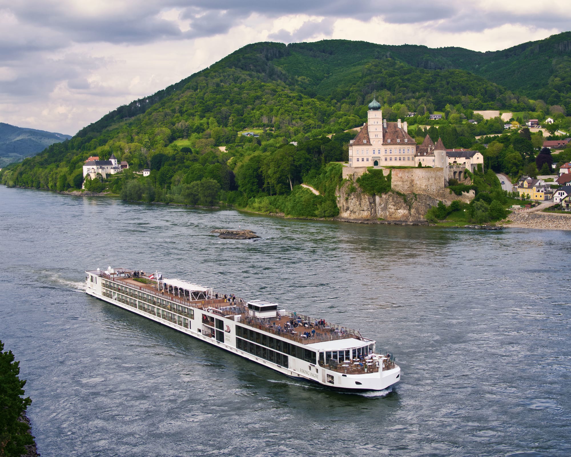 A Viking Longships river cruise vessel navigates the Danube River past Schönbühel Castle