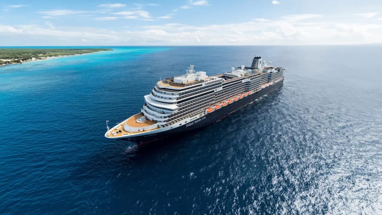 A striking aerial view of the Nieuw Statendam, a Holland America Line cruise ship, anchored