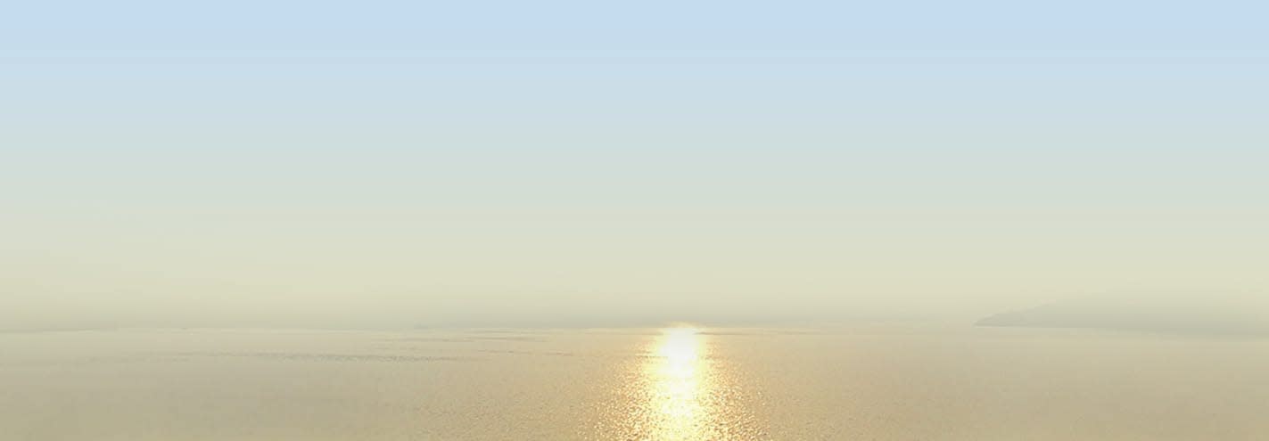 A serene sunrise view over the Yangtze River with golden sunlight reflecting across calm waters