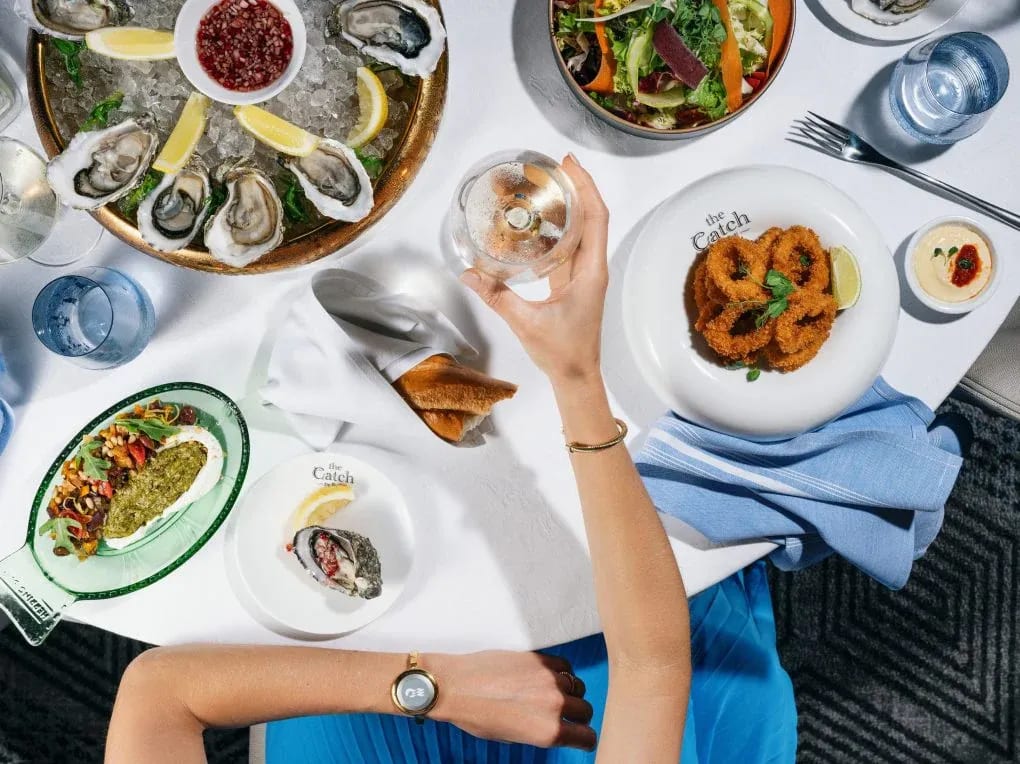 An overhead view of an elegant seafood dining experience at The Catch restaurant aboard a Princess