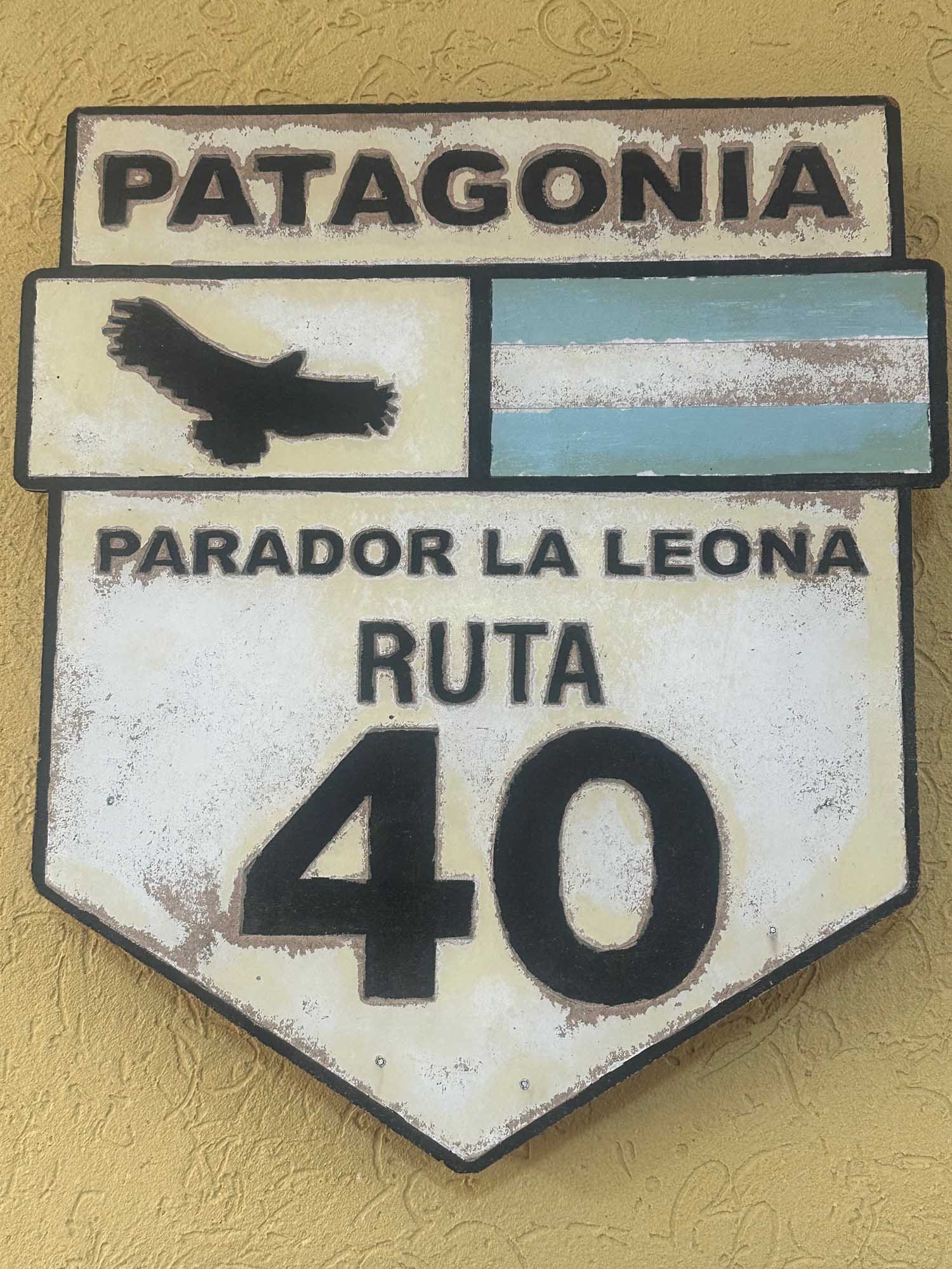 A weathered vintage-style road sign for Patagonia's Route 40 (Ruta 40), featuring the text 'PARADOR