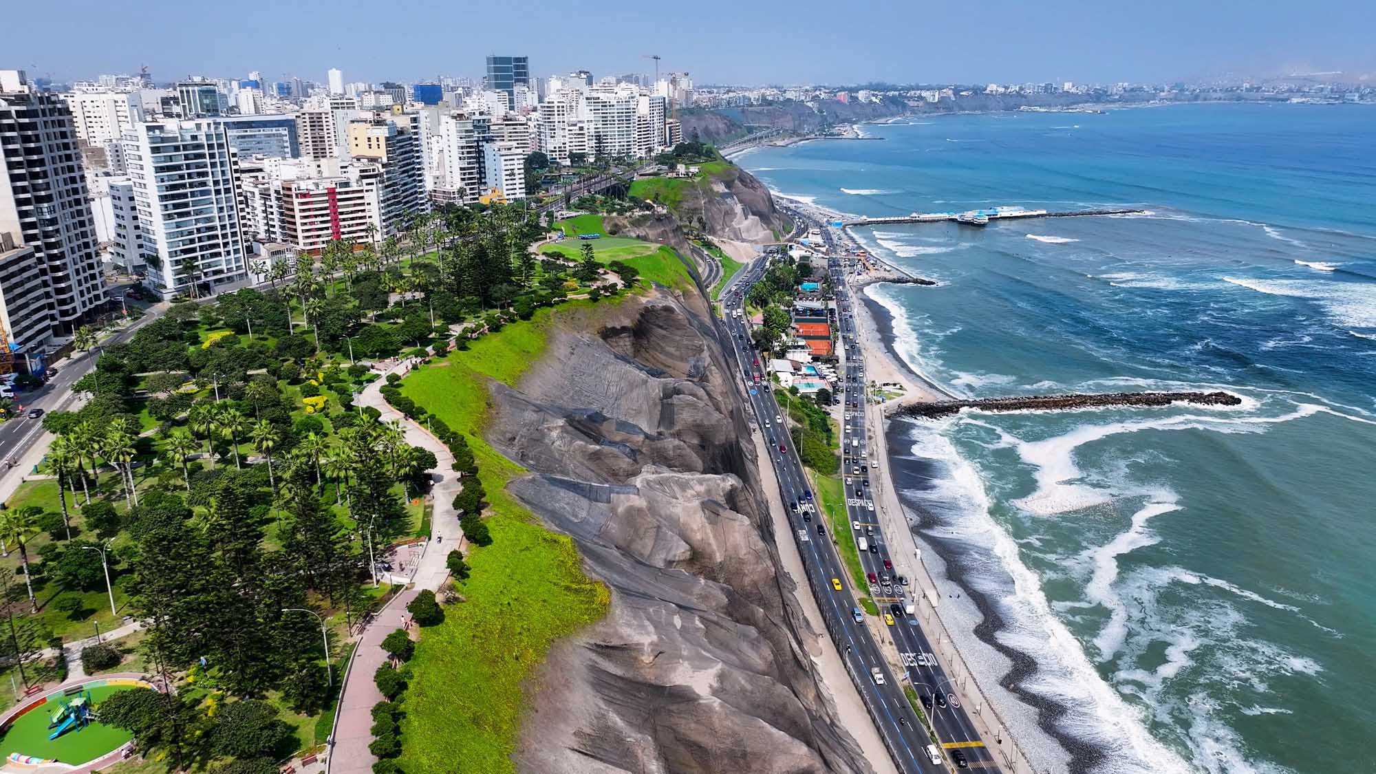 Aerial view of Lima's Miraflores district featuring a verdant clifftop park overlooking the Pacific