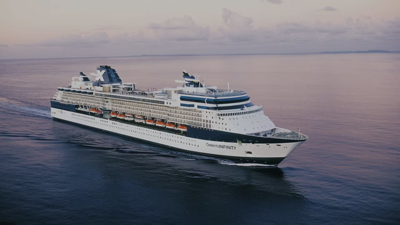 The Celebrity Infinity, a luxury cruise ship operated by Celebrity Cruises, sails across calm blue
