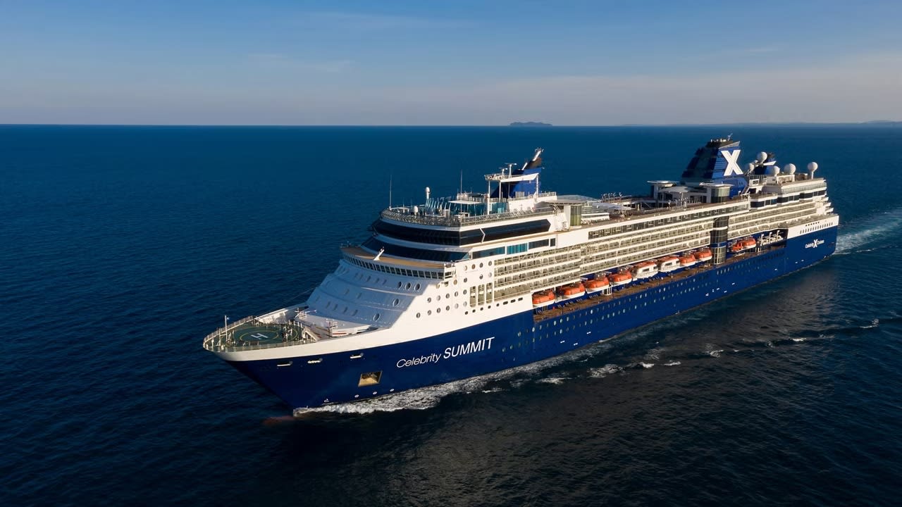 A large modern cruise ship, the Celebrity Summit, photographed from the side while sailing on calm