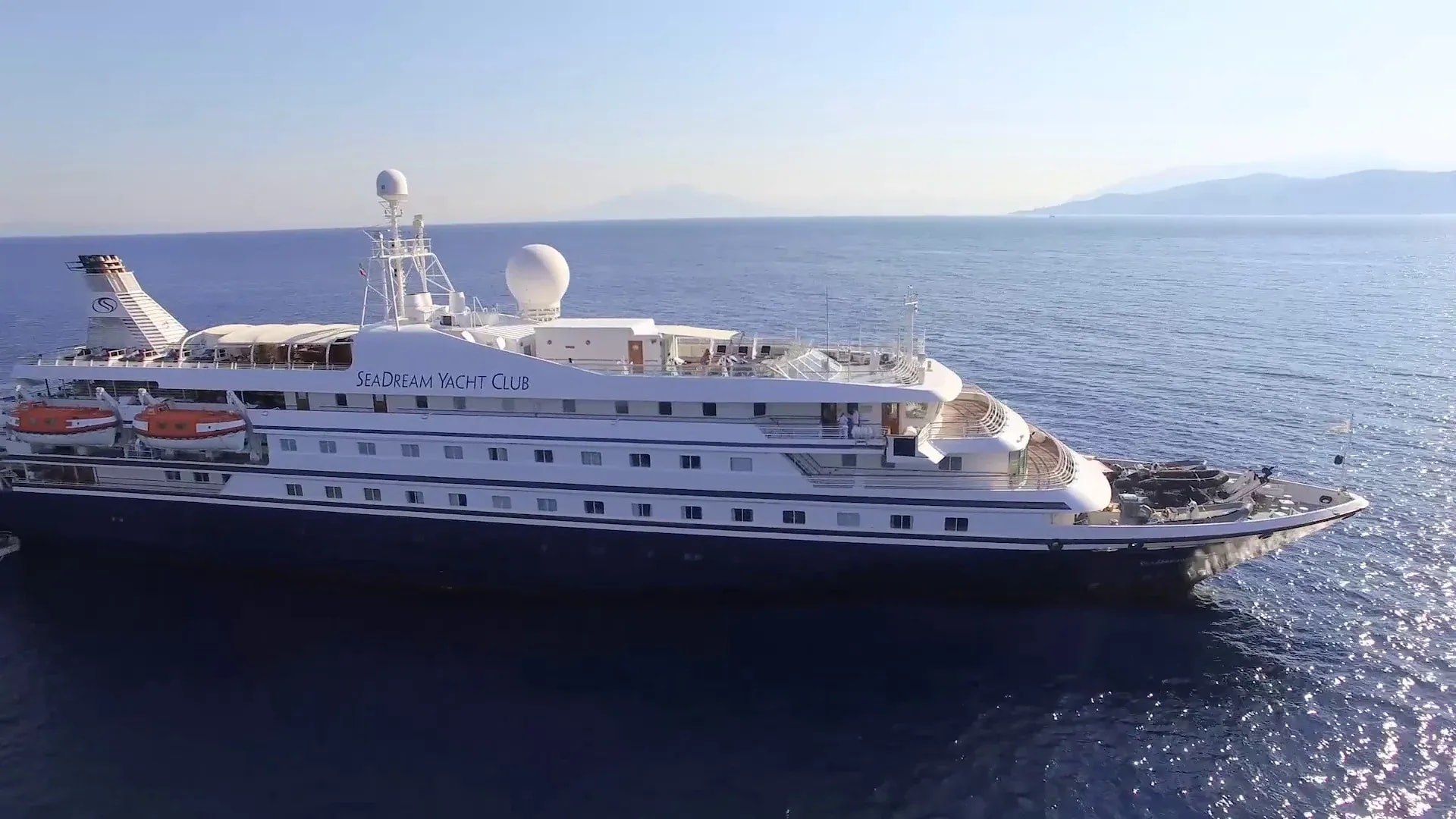 The luxury expedition yacht SeaDream Yacht Club is anchored in calm Mediterranean waters