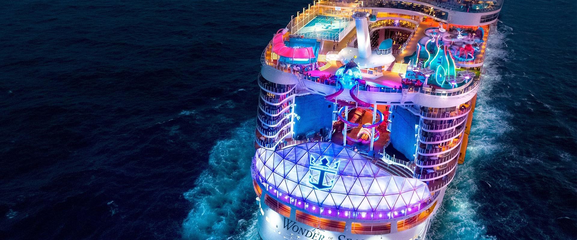 An aerial view of Royal Caribbean's Wonder of the Seas cruise ship at night, showcasing
