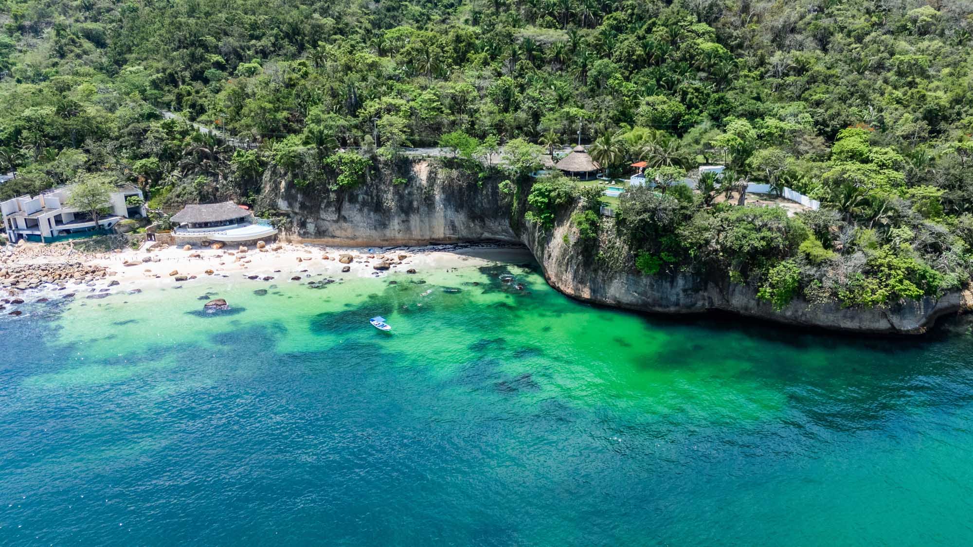 A scenic aerial view of Paredón Beach in Puerto Vallarta, Mexico, featuring pristine turquoise