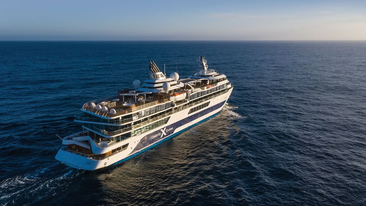 An aerial photograph of the Celebrity Flora, a luxury expedition cruise ship, sailing through