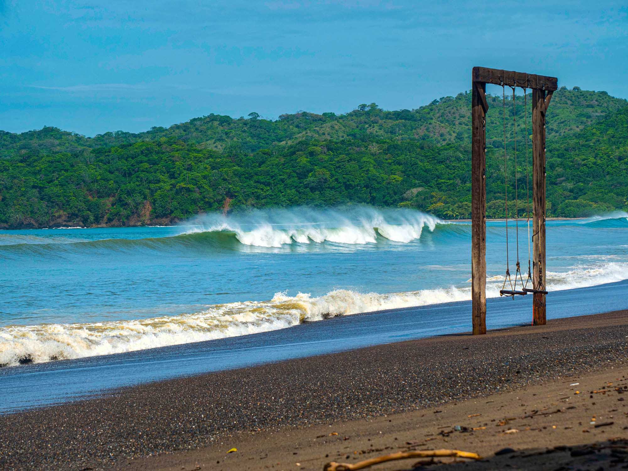 A picturesque tropical beach scene at Playa Venao in Panama, featuring perfect offshore breaking
