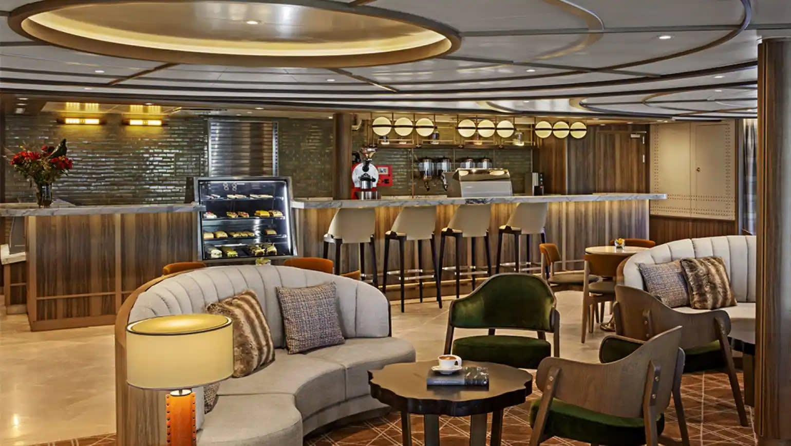 A luxurious ship dining lounge and bar area featuring contemporary design with warm wood paneling