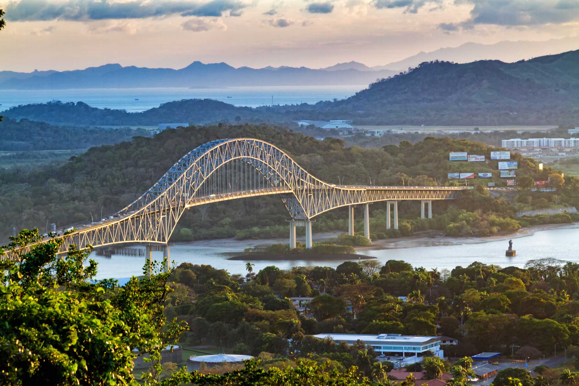 A panoramic aerial view of the iconic Bridge of the Americas spanning the Panama Canal's Pacific