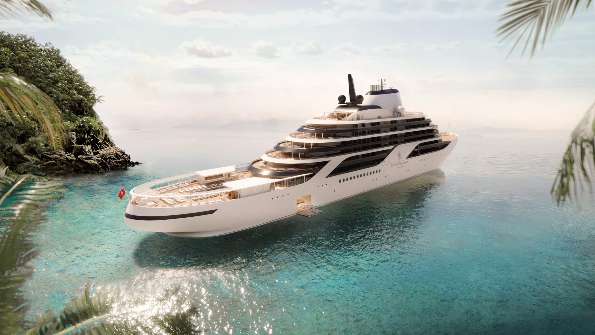 A modern luxury expedition yacht anchored in crystal-clear turquoise tropical waters near a lush