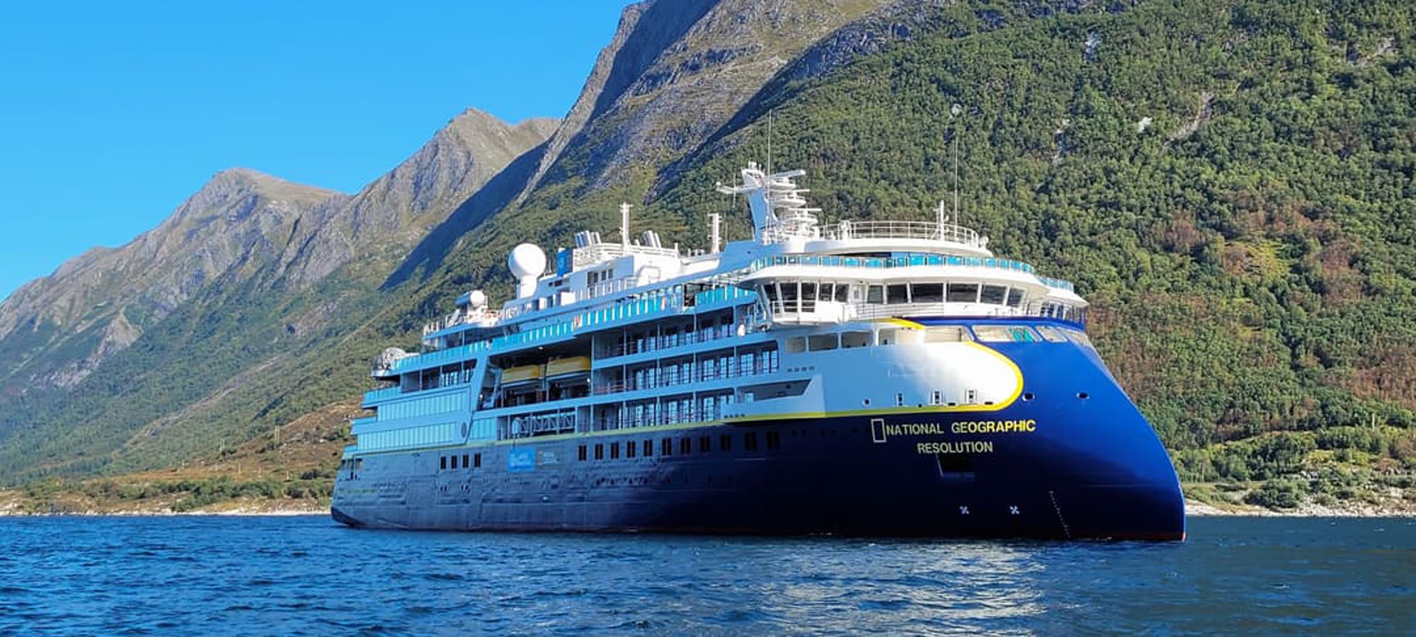 The National Geographic Resolution, a luxury expedition cruise ship, navigates pristine waters