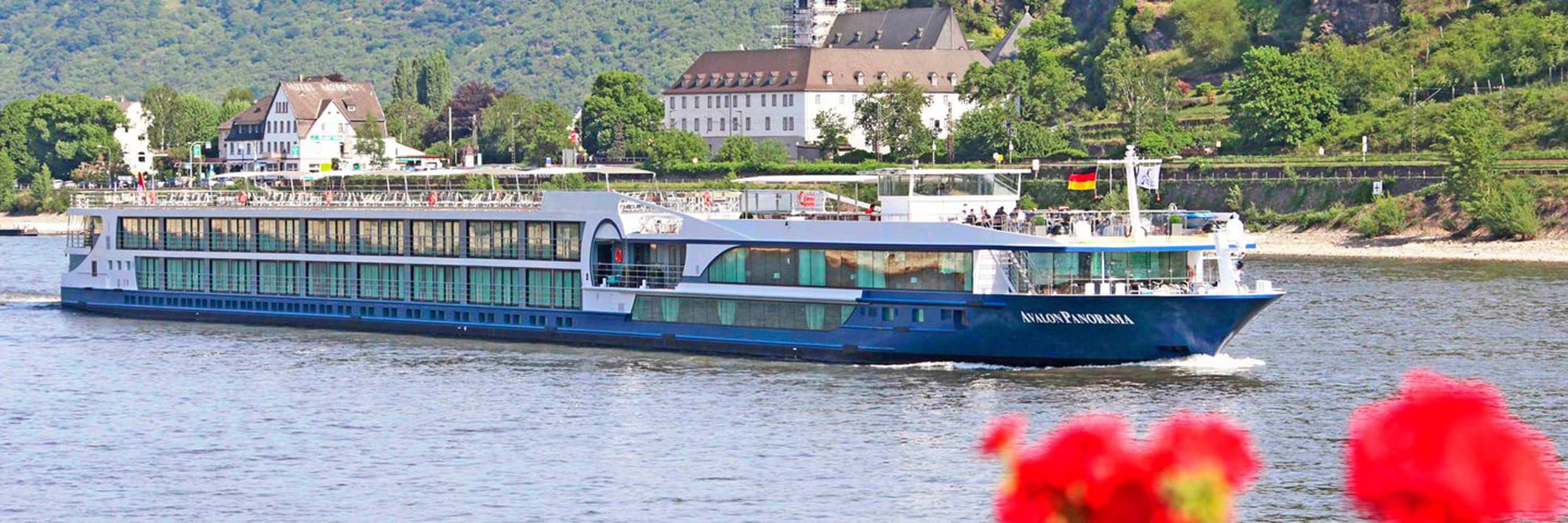 The Avalon Panorama, a modern river cruise ship, navigates the Rhine River past picturesque German