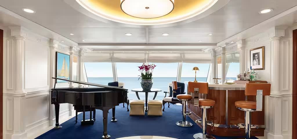 A luxurious owner suite aboard an Oceania Cruises O-Class ship, featuring a black grand piano
