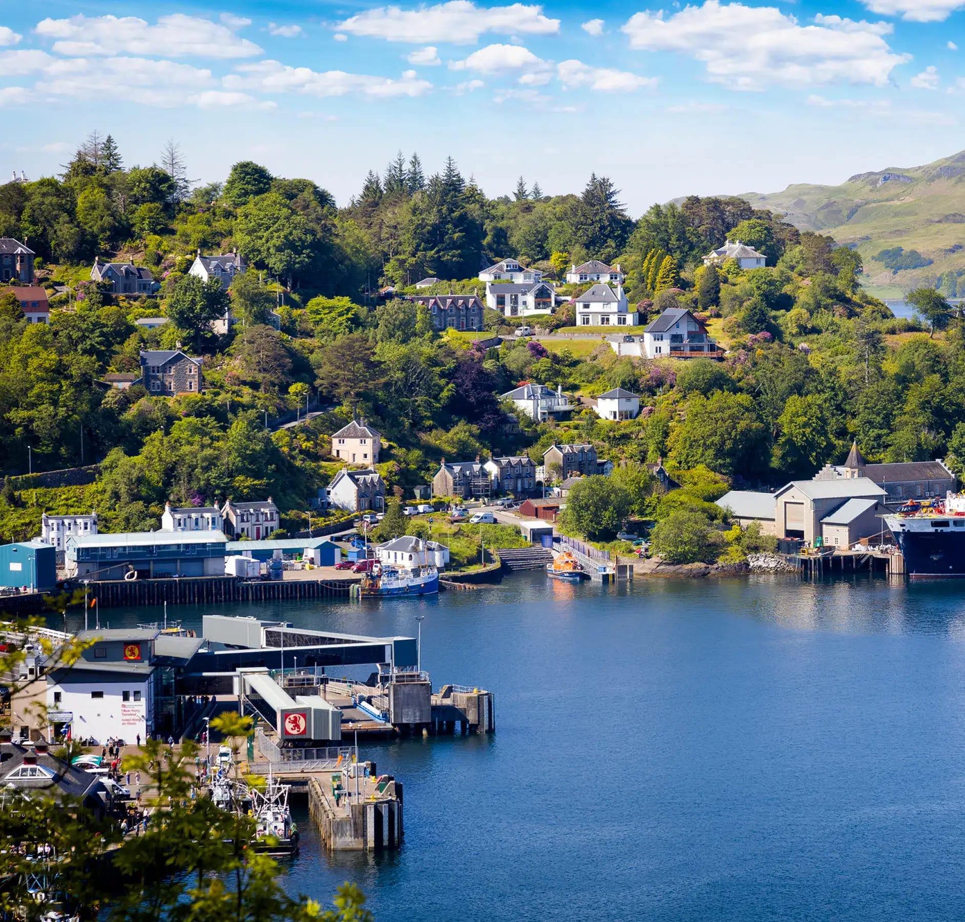 A picturesque Scottish waterfront village nestled in a lush valley with traditional stone