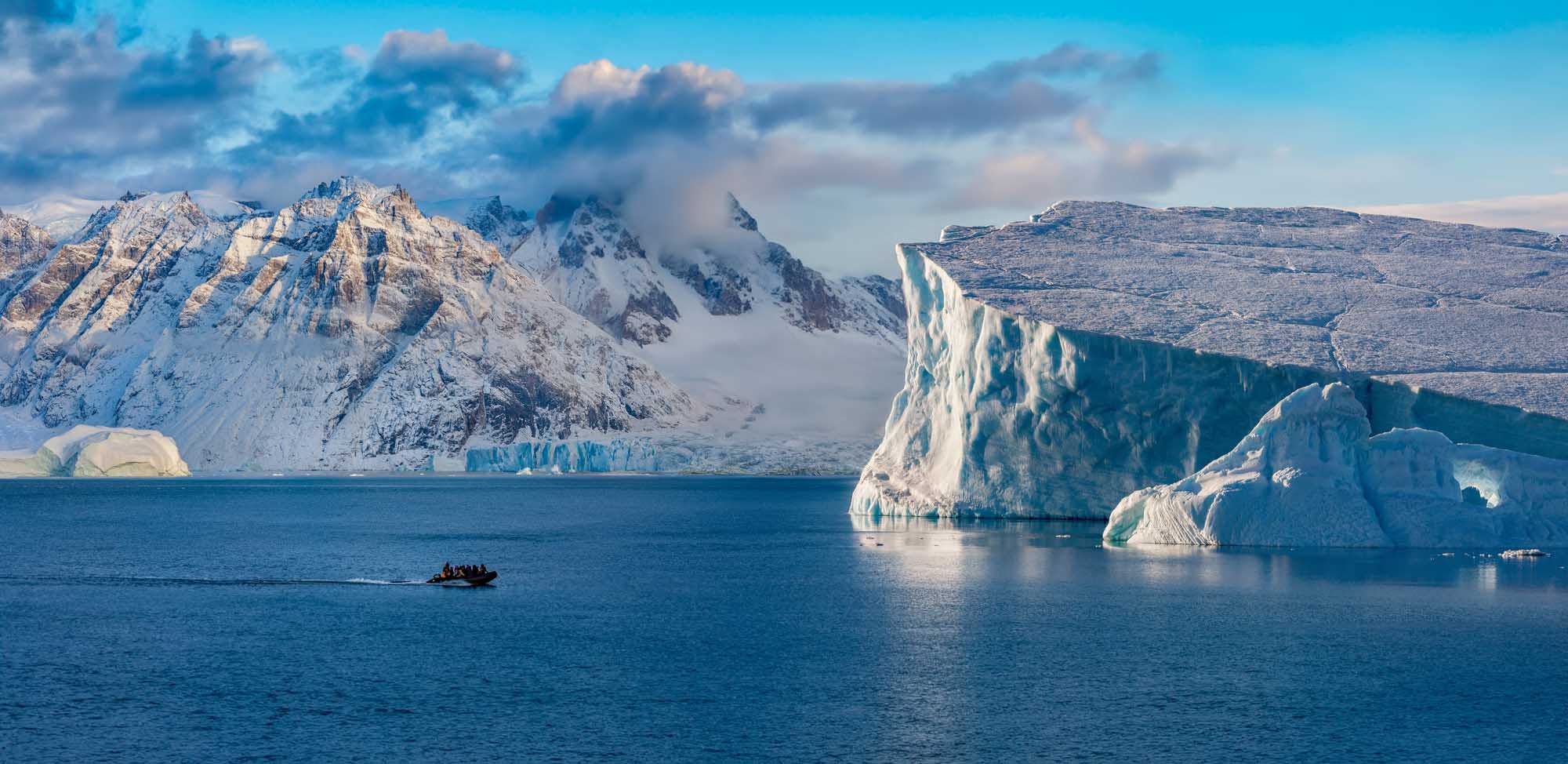 A breathtaking Arctic landscape featuring towering icebergs with striking turquoise hues floating