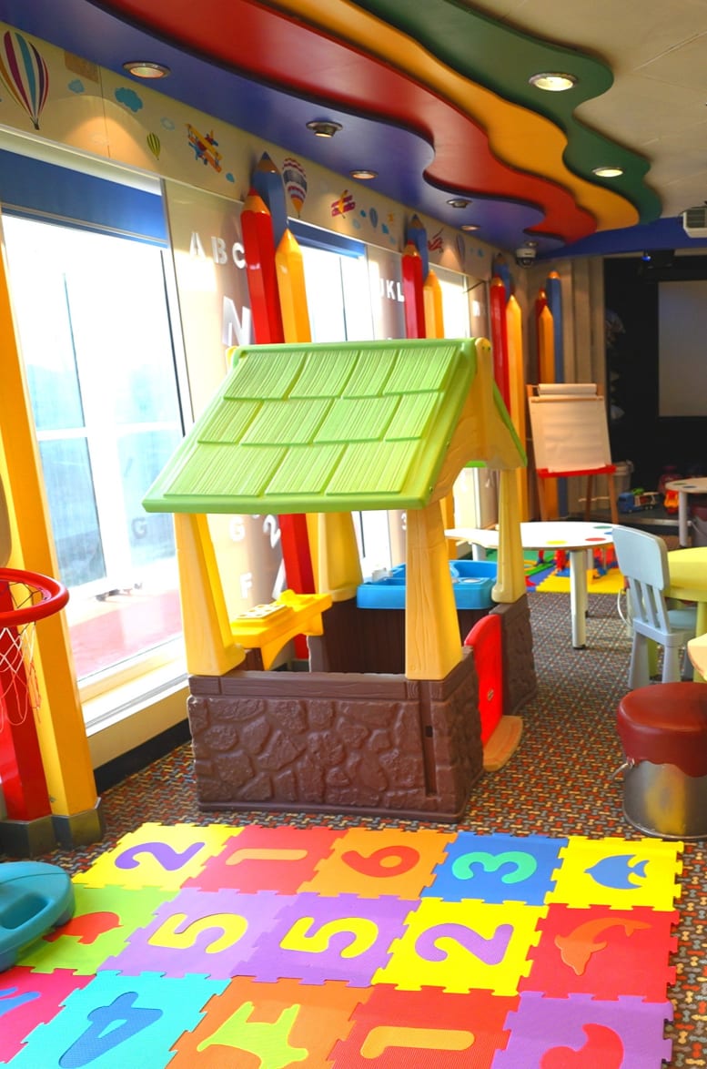 A vibrant, modern children's entertainment space designed for young cruisers, featuring colorful