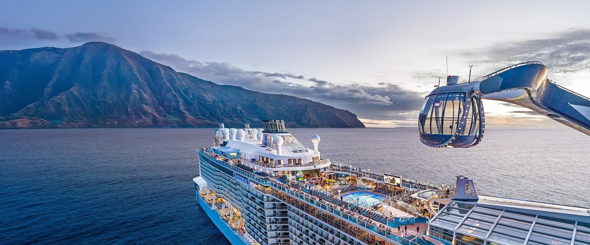 An aerial view of the Royal Caribbean cruise ship Ovation of the Seas anchored in clear blue waters