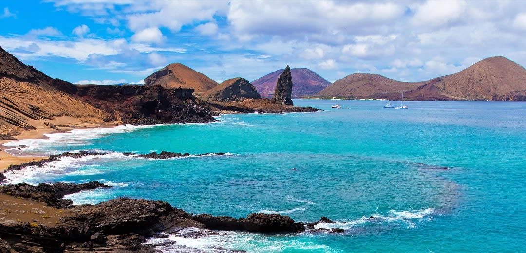A stunning coastal vista of the Galápagos Islands featuring pristine turquoise waters, dark