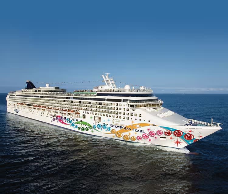 The Norwegian Pearl, a large modern cruise ship operated by Norwegian Cruise Line, sails on open