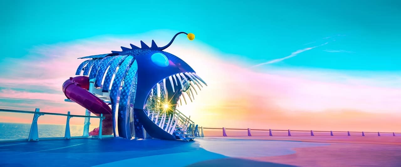 A surreal, oversized blue fish-shaped installation with illuminated details, dramatic spiky dorsal