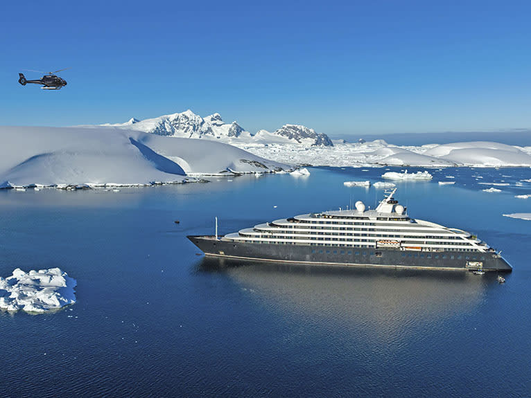 A luxury expedition cruise ship, the Silversea Eclipse, anchored in pristine Antarctic waters