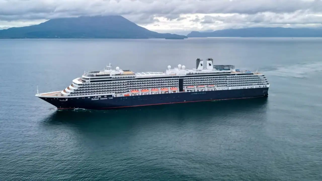 A striking side profile of the Holland America Line cruise ship Noordam anchored in calm waters