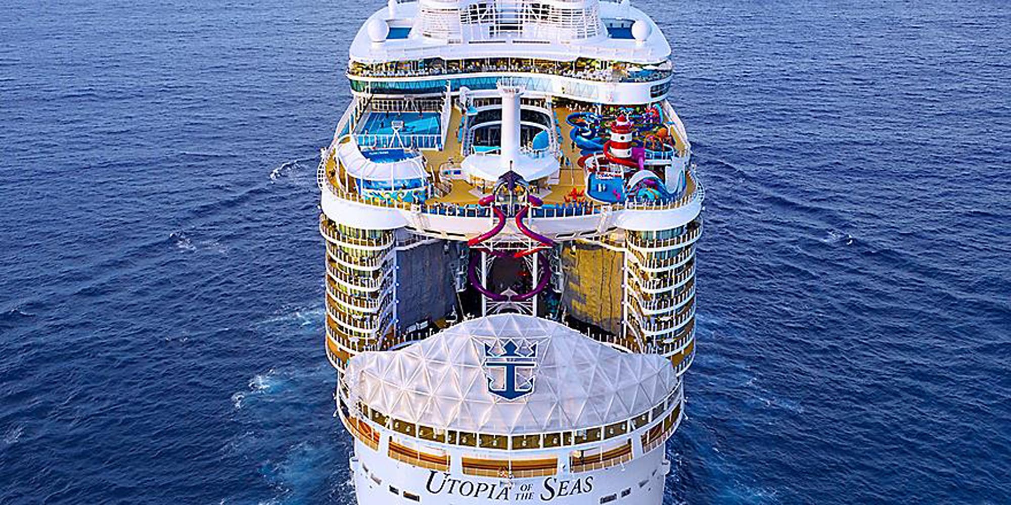 An aerial bow-on view of the Utopia of the Seas cruise ship at sea, displaying its distinctive