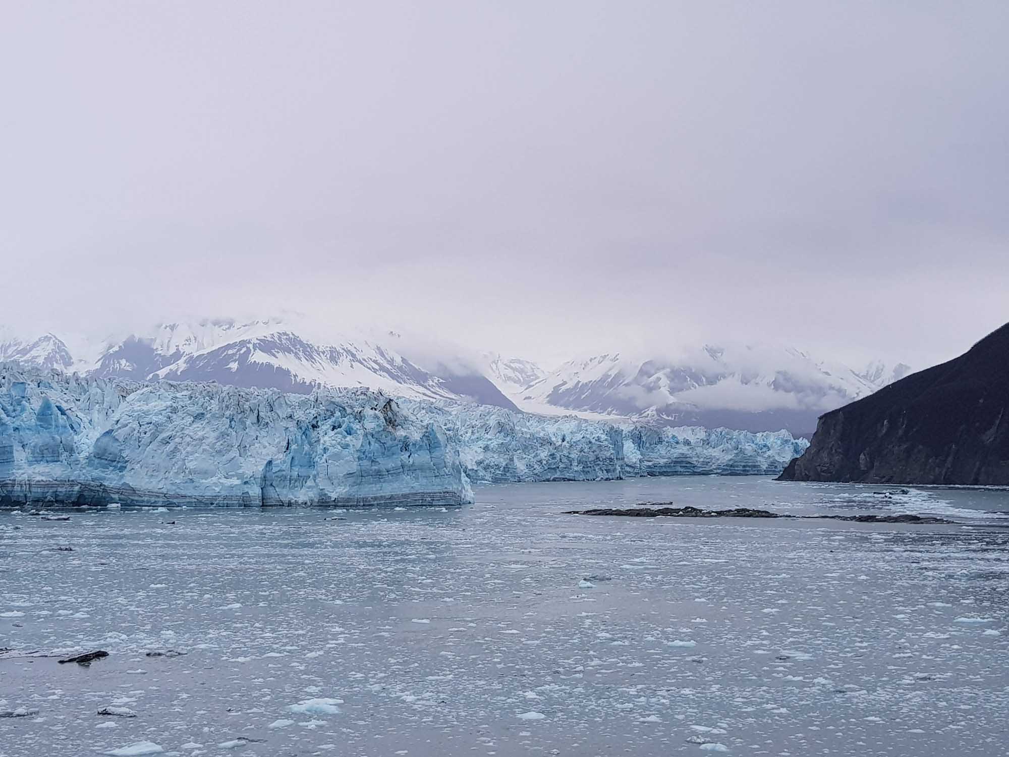 A pristine view of tidewater glaciers meeting the sea in Glacier Bay, with massive blue-ice cliffs