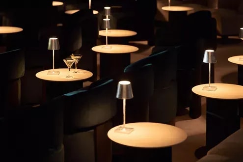 An elegant lounge area aboard an Explora Journeys vessel, featuring a sophisticated modern design