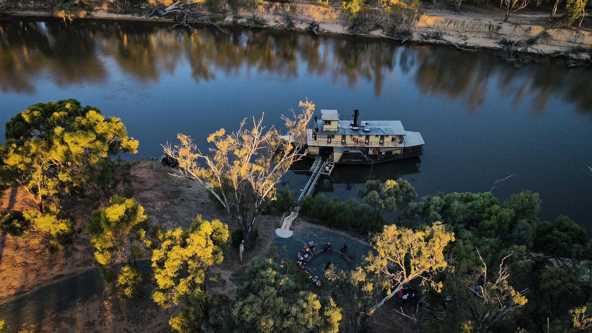 An aerial view of a paddlewheel riverboat moored along the Murray River in Australia