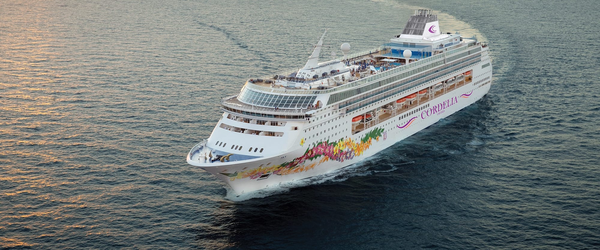 An aerial photograph of the Norwegian Sky cruise ship sailing near Miami, showcasing the vessel's