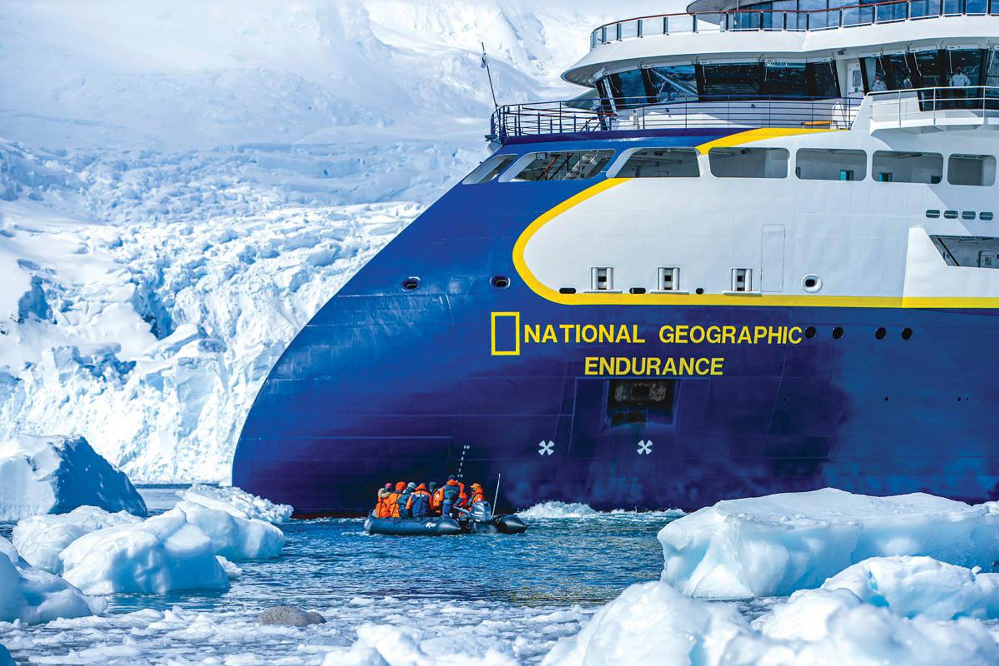 The National Geographic Endurance, a modern expedition cruise ship, navigates through icebergs