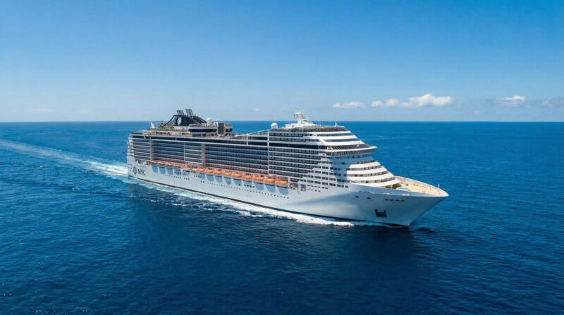 c9fe0493-6dbb-4cd6-9bc4-d921152fb0e6 Large white cruise ship with orange lifeboat covers sailing on open blue ocean under clear sky