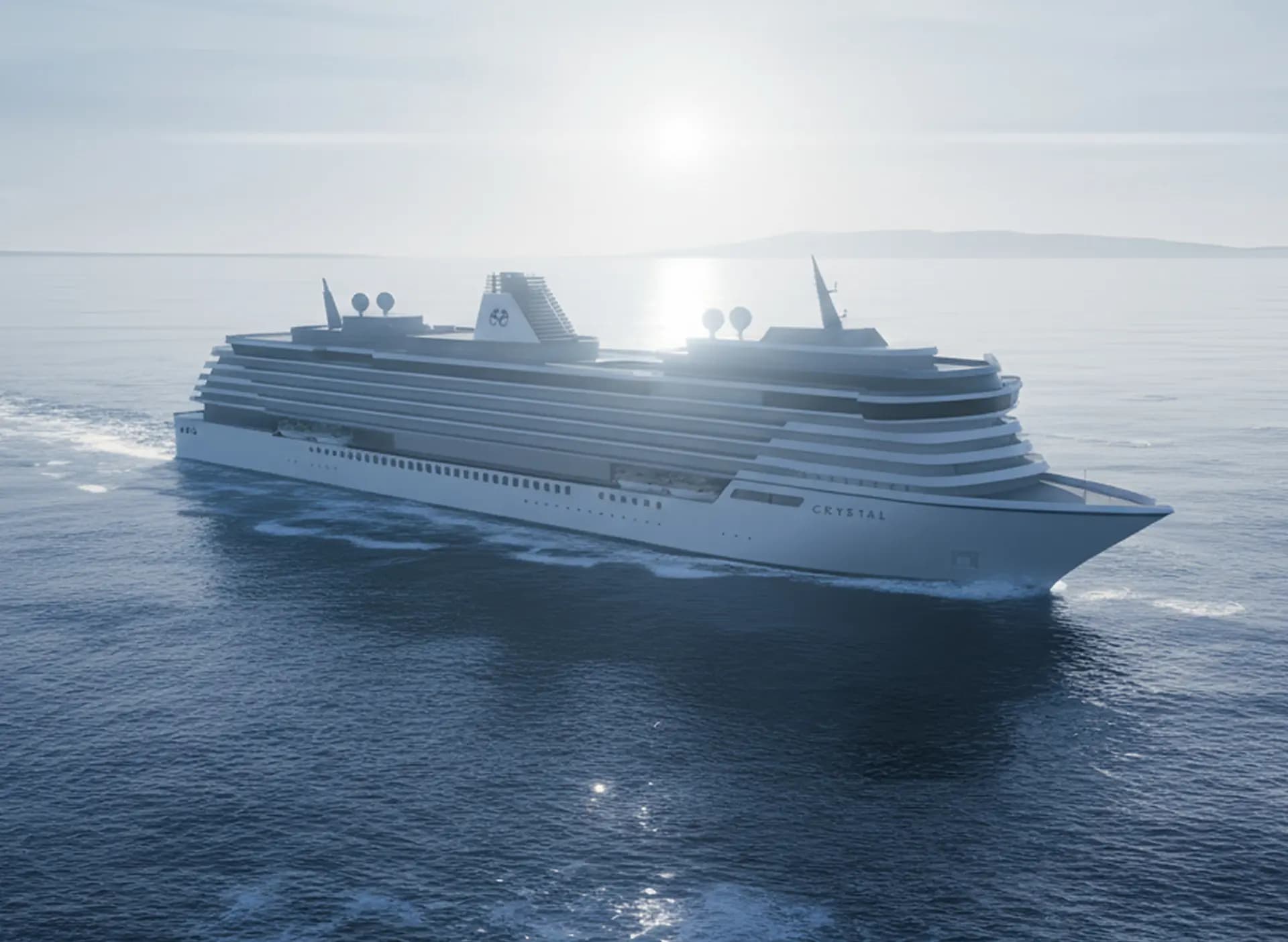 Crystal Serenity cruise ship sailing across calm blue waters under overcast skies, displaying elegant tiered deck architecture and dual funnels.