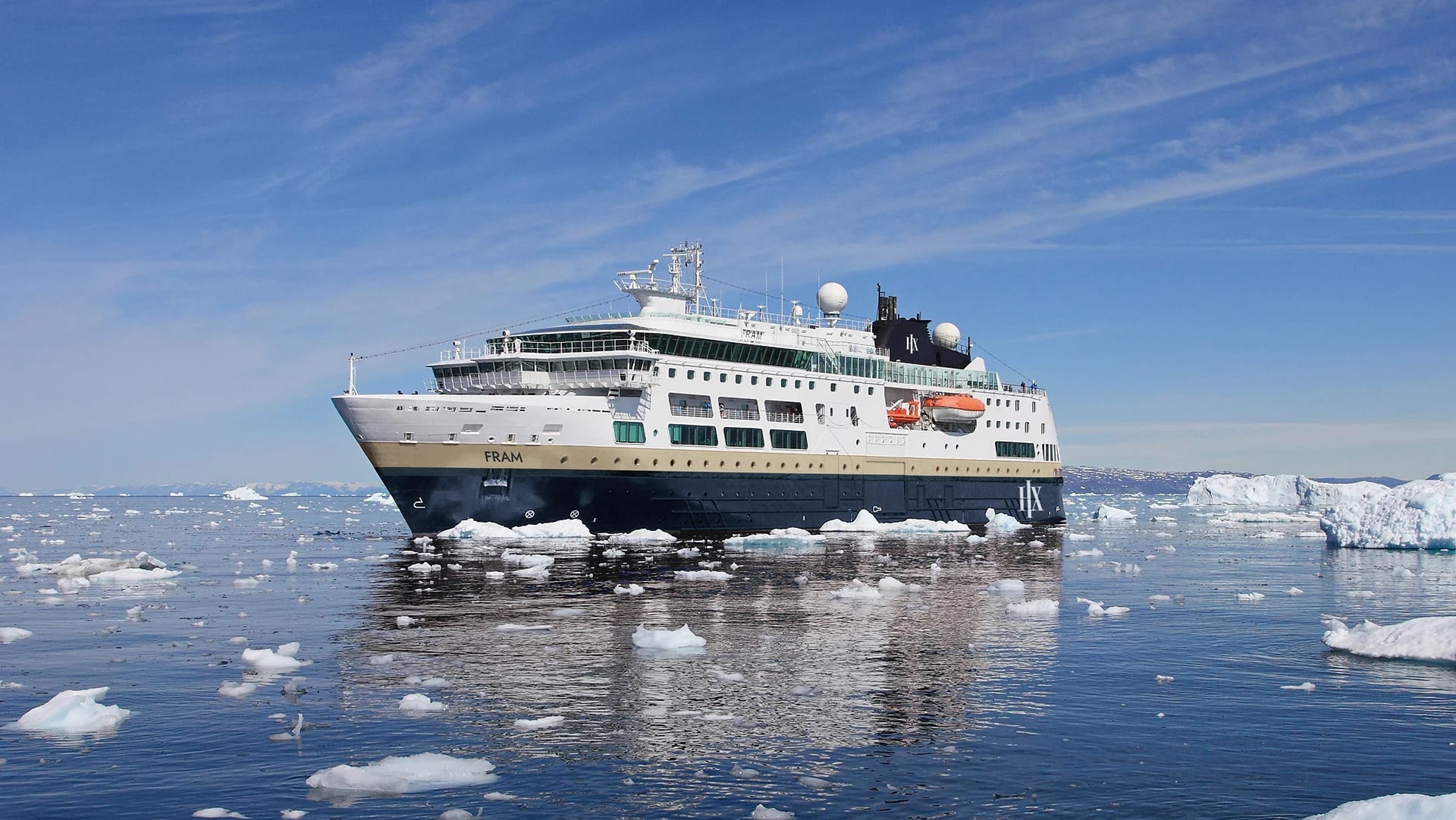 The expedition cruise ship Fram navigating through icy waters surrounded by floating ice fragments